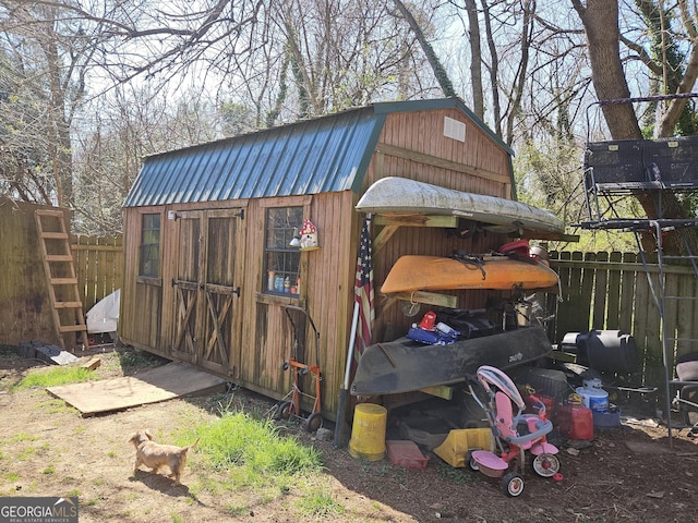 view of outbuilding with an outbuilding and fence