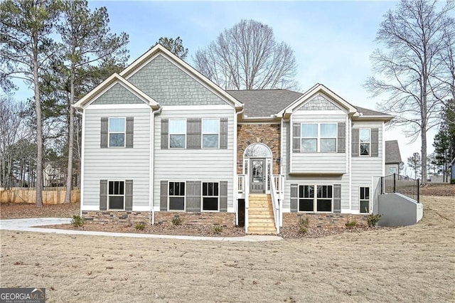 bi-level home featuring stone siding