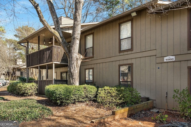 exterior space with a balcony and ceiling fan