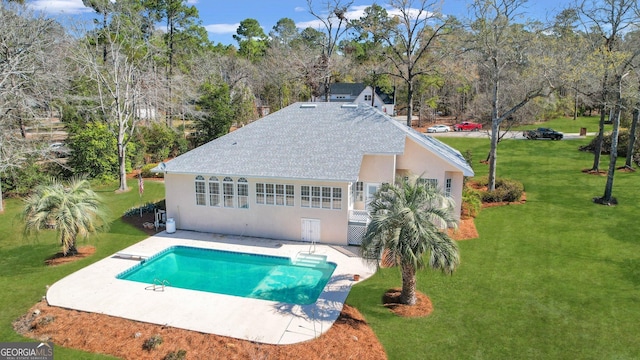 outdoor pool featuring a patio area and a lawn