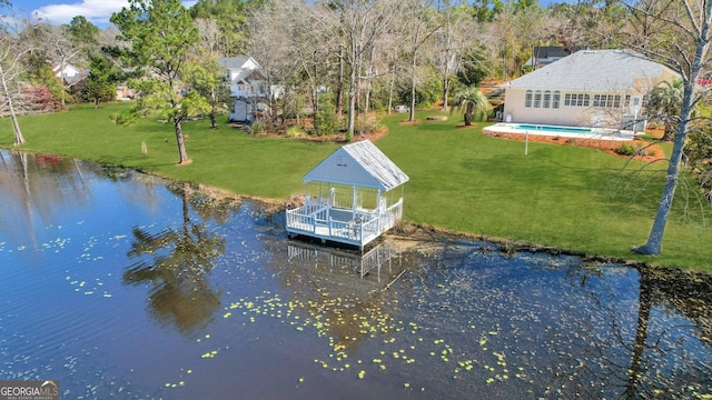 view of dock featuring an outdoor pool, a water view, and a lawn