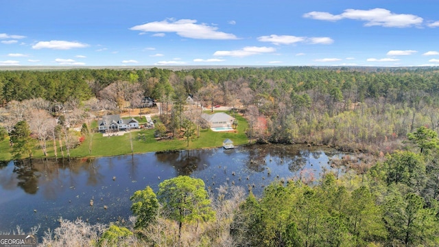 drone / aerial view featuring a view of trees and a water view