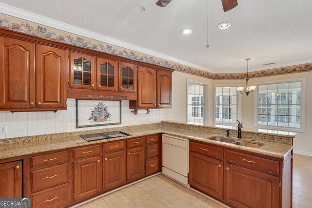 kitchen with a sink, a peninsula, brown cabinetry, white dishwasher, and black electric cooktop