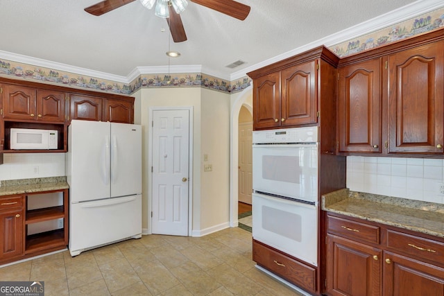 kitchen with visible vents, tasteful backsplash, white appliances, light stone countertops, and ceiling fan