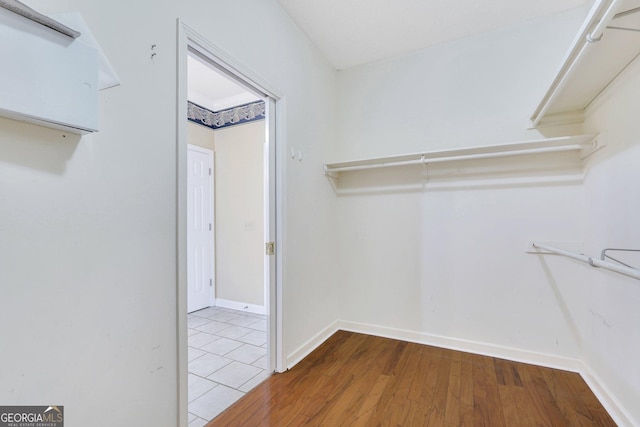 spacious closet featuring wood finished floors