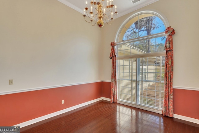 interior space with a healthy amount of sunlight, crown molding, baseboards, and hardwood / wood-style flooring