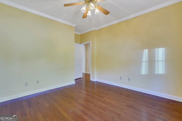 empty room with ceiling fan, crown molding, baseboards, and wood finished floors