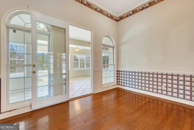 spare room with hardwood / wood-style floors, plenty of natural light, and ceiling fan