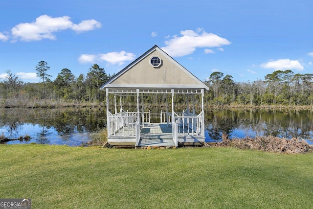 view of dock with a lawn and a water view