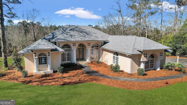 view of front of home with stucco siding and a front yard