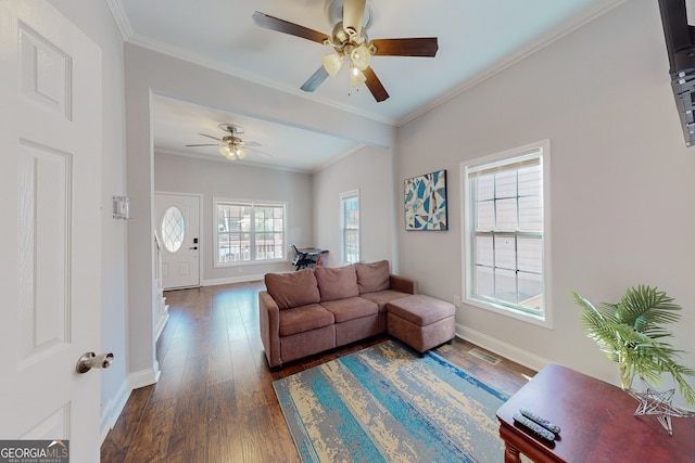 living room with dark wood finished floors, visible vents, crown molding, and baseboards