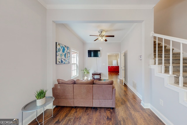 living room with dark wood finished floors, stairs, and ornamental molding