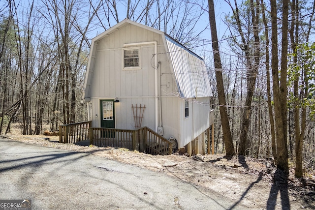 colonial inspired home with a gambrel roof and metal roof