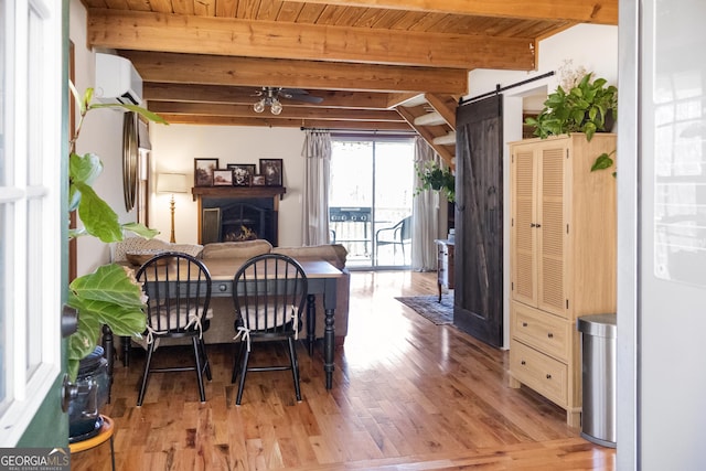 dining space with a fireplace, a barn door, beamed ceiling, and wood ceiling