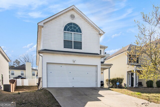 traditional-style house featuring central AC unit, an attached garage, concrete driveway, and fence