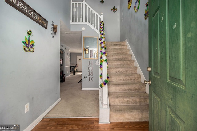 stairs featuring baseboards and wood finished floors