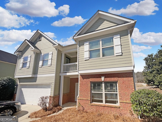 view of front of house featuring a balcony, a garage, brick siding, and driveway