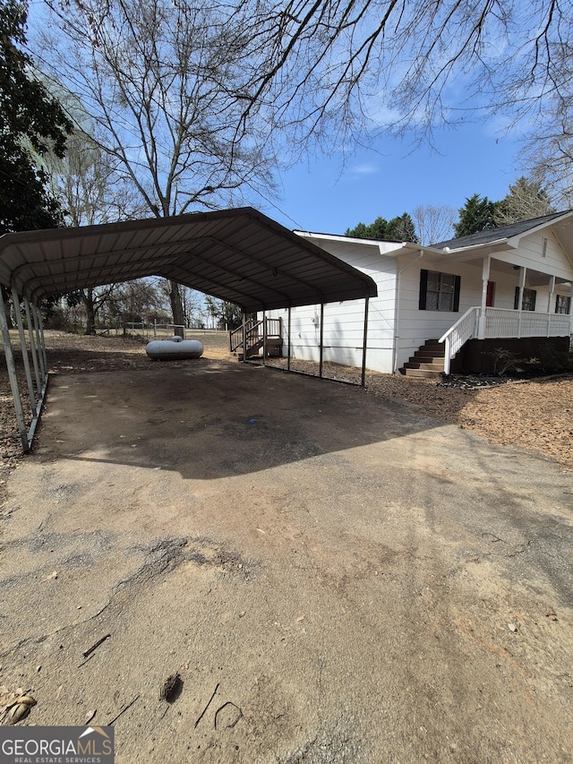 view of car parking featuring a detached carport and aphalt driveway