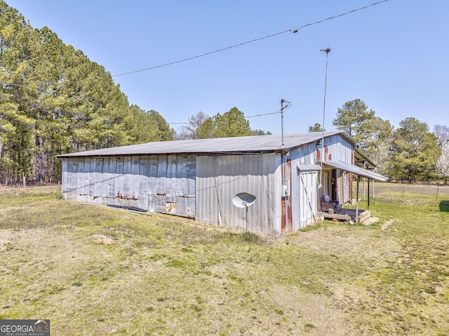 view of pole building with a yard