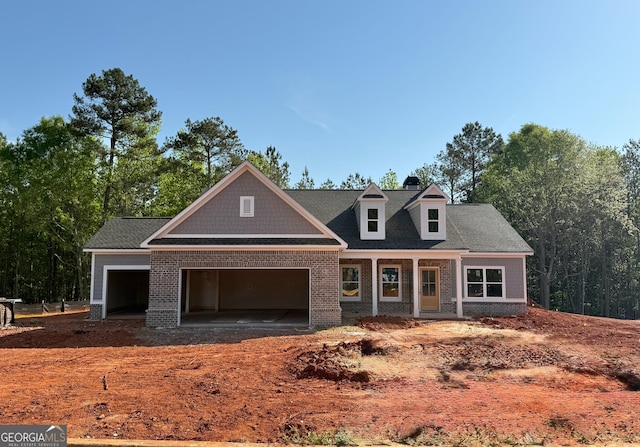 craftsman-style home with a garage and brick siding