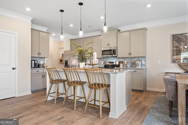 146 Silver Leaf Trce, Douglasville, GA 30134 - kitchen featuring a kitchen island, a kitchen bar, gray cabinets, light wood-style floors, and stainless steel appliances