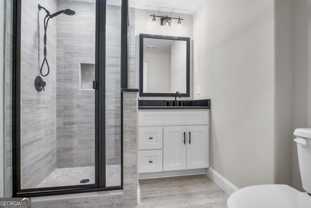 202 Via Lucca, Woodstock, GA 30188 - full bathroom featuring a stall shower, toilet, vanity, and baseboards