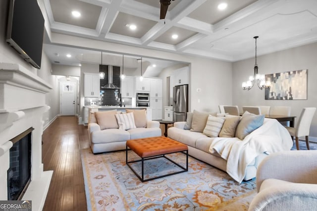 202 Via Lucca, Woodstock, GA 30188 - living room with hardwood / wood-style floors, coffered ceiling, a fireplace with raised hearth, beamed ceiling, and a chandelier