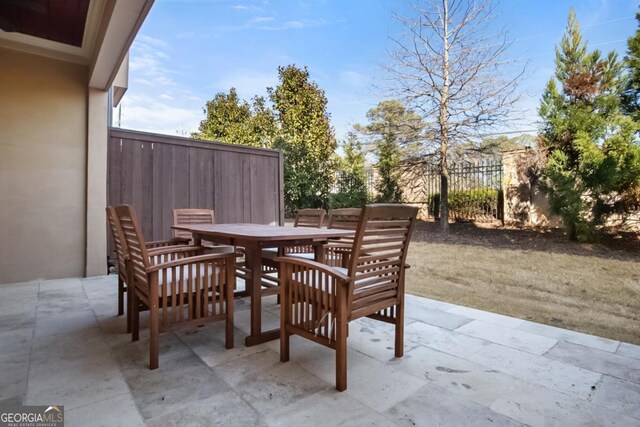 202 Via Lucca, Woodstock, GA 30188 - view of patio featuring outdoor dining space and fence