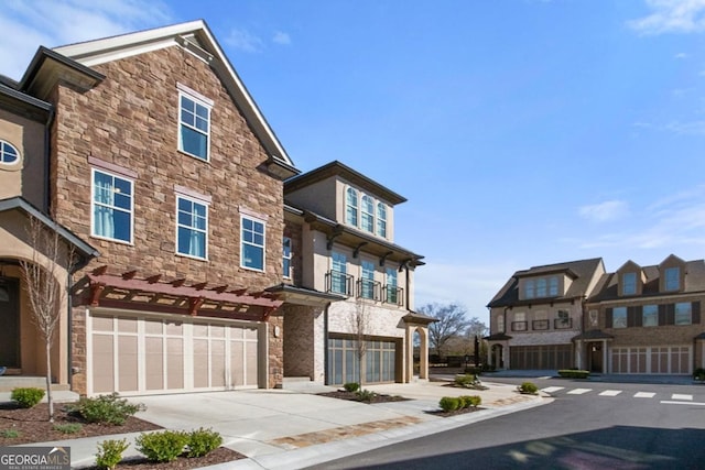 view of front of home with concrete driveway, a garage, and stucco siding