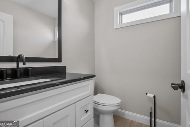 202 Via Lucca, Woodstock, GA 30188 - bathroom with vanity, toilet, wood finished floors, and baseboards