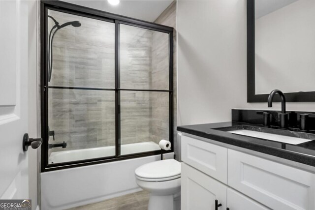 202 Via Lucca, Woodstock, GA 30188 - full bath featuring combined bath / shower with glass door, toilet, vanity, and wood finished floors