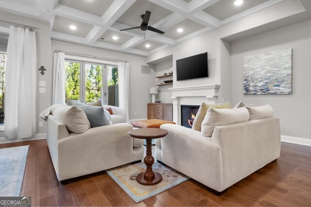 202 Via Lucca, Woodstock, GA 30188 - living room featuring a glass covered fireplace, dark wood-type flooring, beamed ceiling, and visible vents