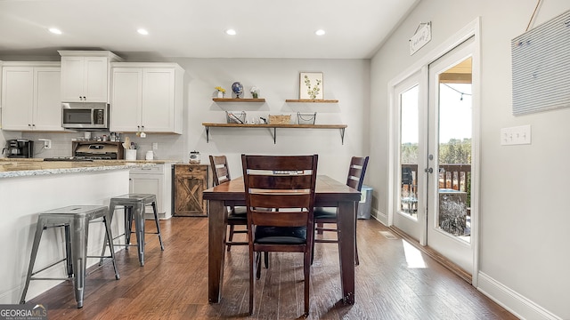 dining area with dark wood finished floors, recessed lighting, french doors, and baseboards