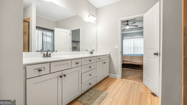 full bathroom featuring ensuite bath, double vanity, a ceiling fan, and a sink