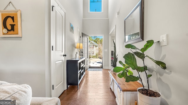 entrance foyer with dark wood finished floors and a high ceiling