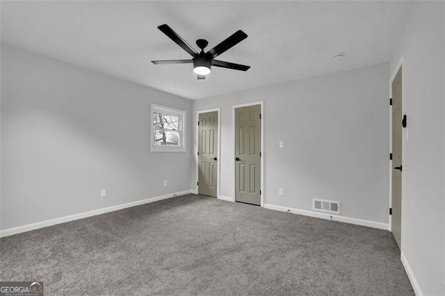 unfurnished bedroom featuring carpet flooring, baseboards, and visible vents