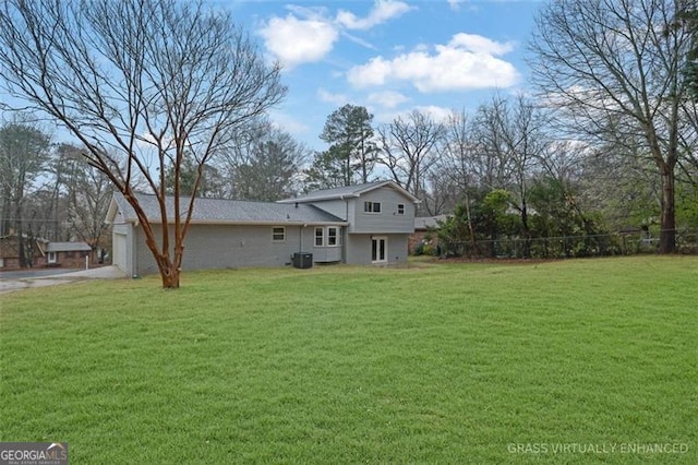 view of yard featuring driveway, a garage, and fence