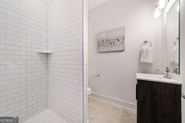 2664 Brown St NW, Atlanta, GA 30318 - full bath with baseboards, toilet, a tile shower, tile patterned floors, and vanity