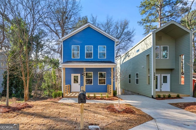 view of front of home featuring a carport, covered porch, and driveway