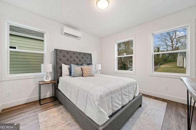 2664 Brown St NW, Atlanta, GA 30318 - bedroom with an AC wall unit, baseboards, and wood finished floors