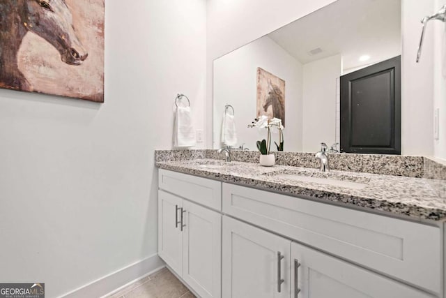 2664 Brown St NW, Atlanta, GA 30318 - bathroom featuring tile patterned flooring, double vanity, baseboards, and a sink