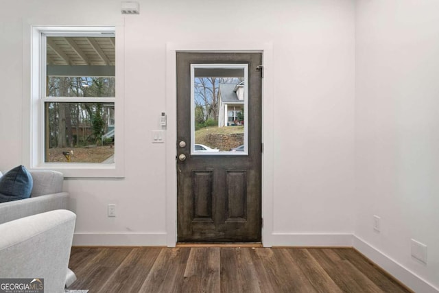 entryway featuring baseboards and wood finished floors