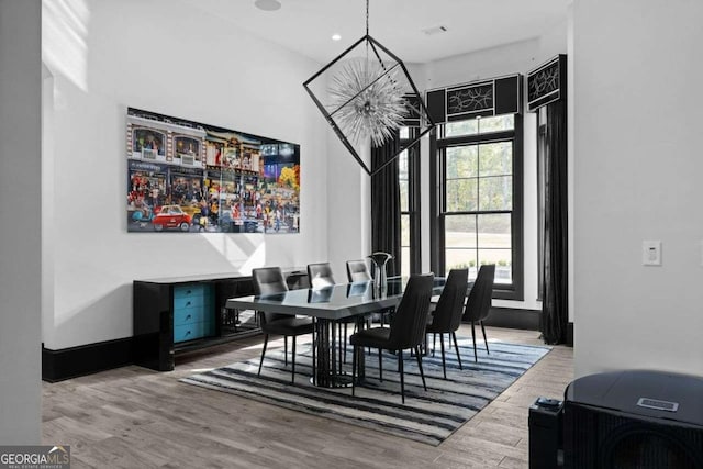 dining space with recessed lighting, wood finished floors, and visible vents