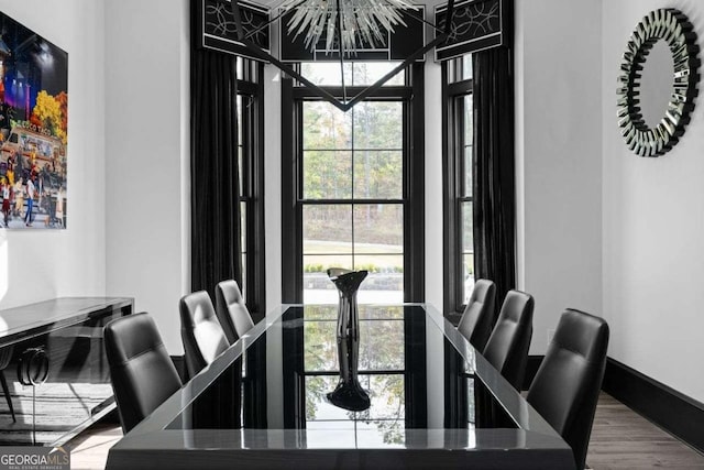 dining room featuring baseboards and wood finished floors