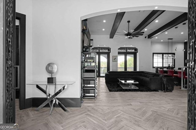 living area featuring beam ceiling, recessed lighting, arched walkways, and ceiling fan