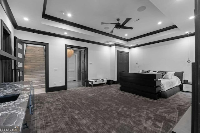 carpeted bedroom featuring crown molding, ceiling fan, baseboards, recessed lighting, and a raised ceiling