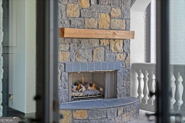 interior details featuring arched walkways and a stone fireplace