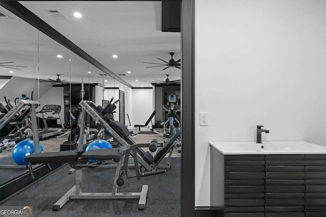 exercise room featuring visible vents, recessed lighting, ceiling fan, and a sink