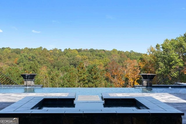 view of storm shelter with a wooded view