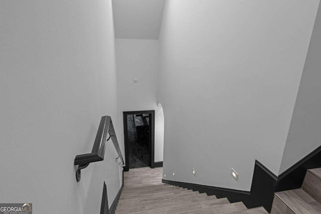 stairway featuring baseboards and wood finished floors